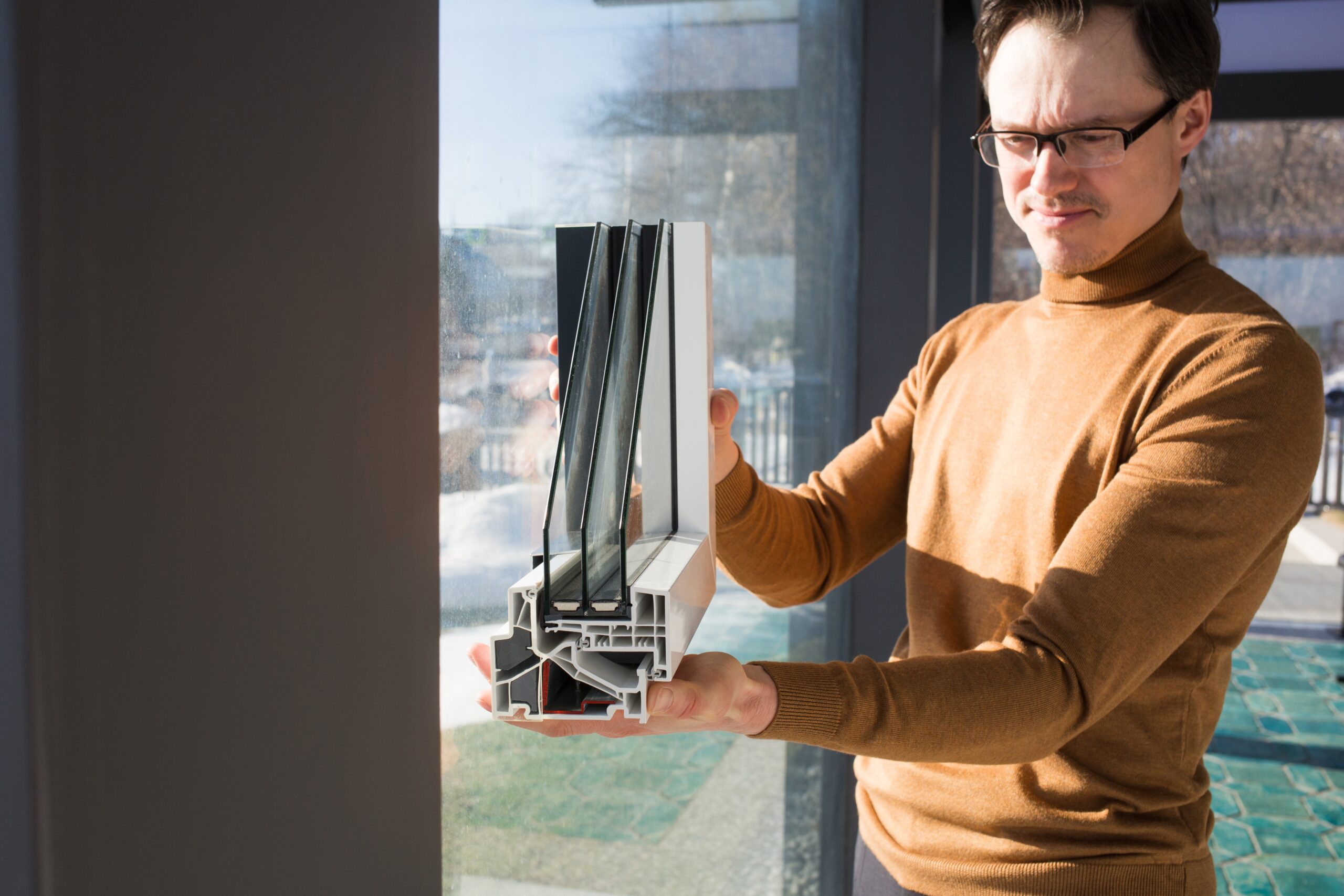 About Us 1 a man looking at the double glazing